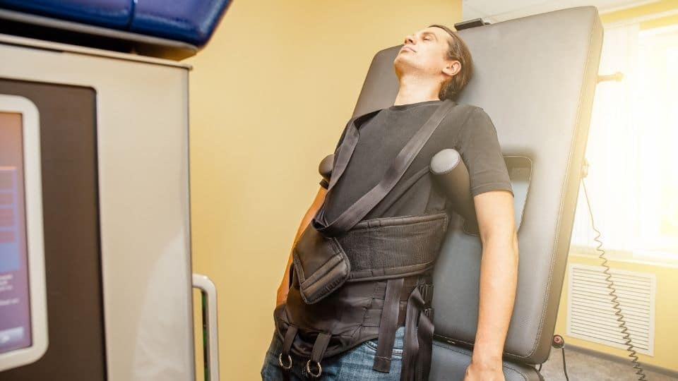 A patient on a non-surgical spinal decompression table