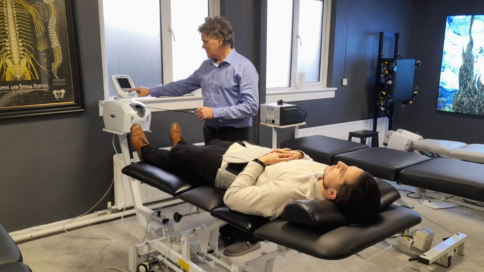 Dr Lawrence Woods treating a patient on the spinal decompression table at the Glenageary clinic